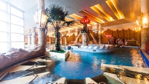 An indoor swimming pool with a waterfall feature, surrounded by stone columns and a reception area. - Sono Belle Byeonsan (Buan)