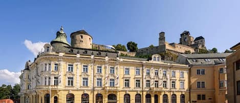 A historic building with classical architecture, featuring a central courtyard and a prominent tower.