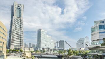 A modern cityscape with high-rise buildings, a bridge, and a river.