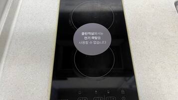 A Samsung induction cooktop with a control panel and a circular interface.