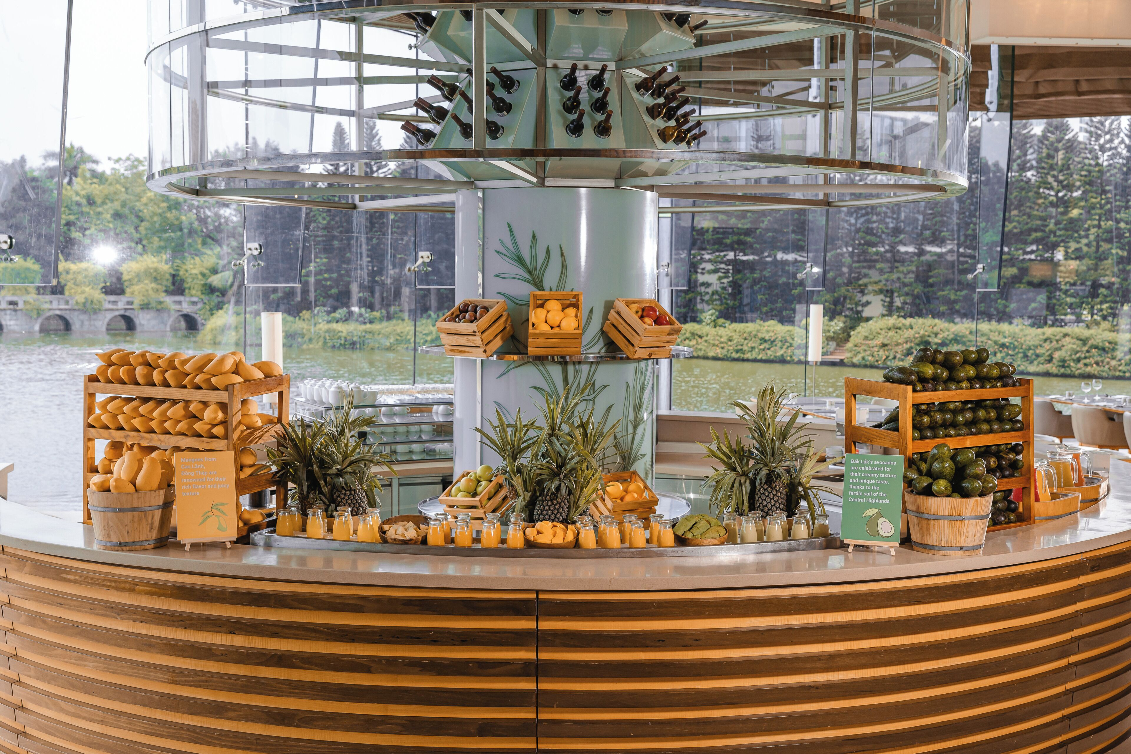A breakfast buffet with various fruits, juices, and bread.