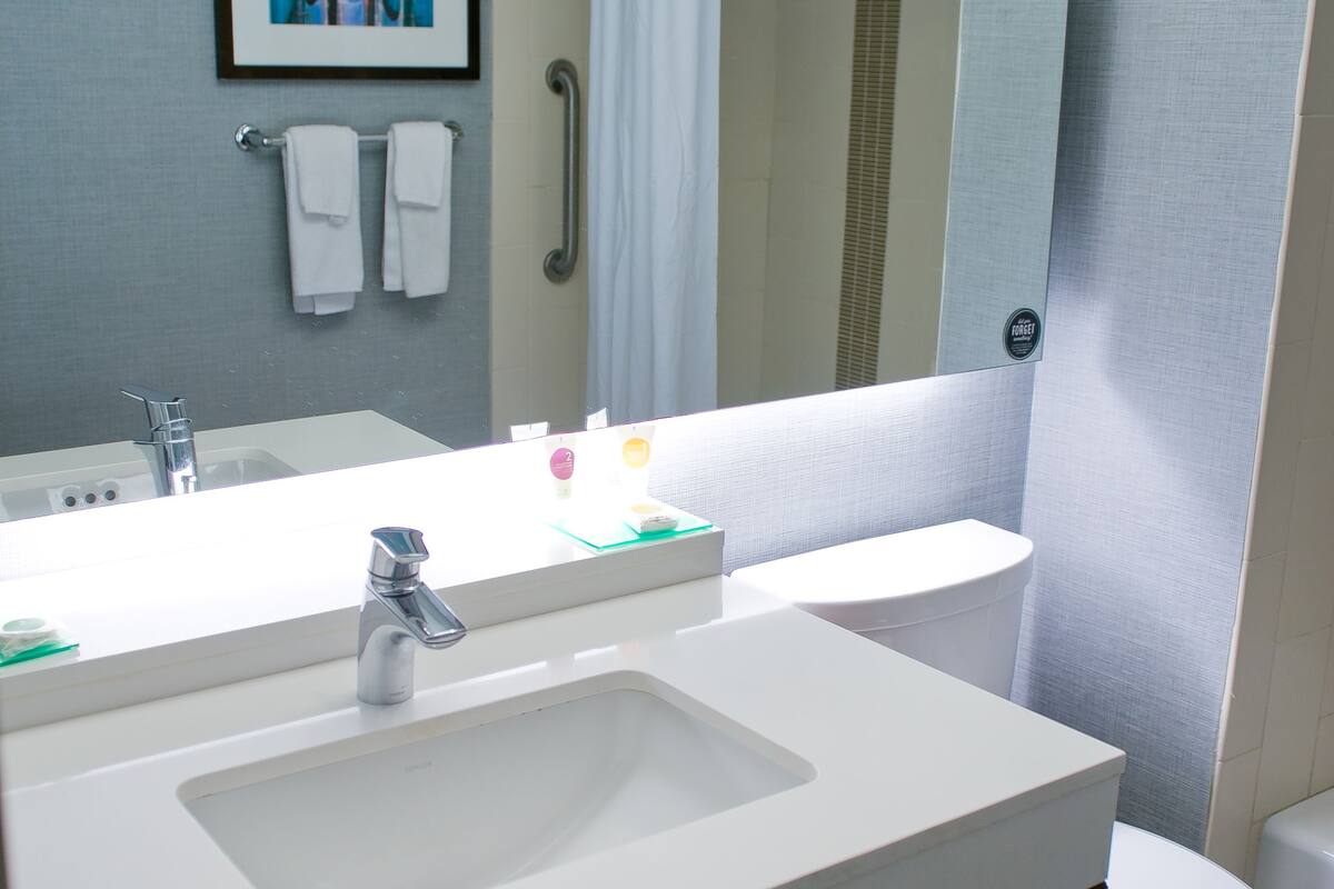 designer toiletries, hair dryer, towels, soap