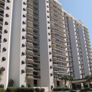 A high-rise building with multiple balconies and a uniform facade.
