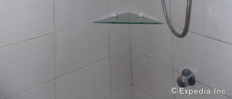 A shower with a handheld showerhead and a wall-mounted control panel.