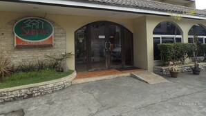 A building with a sign for 'The Suites at Calle Nueva'. - The Suites at Calle Nueva (Bacolod)