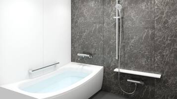 A modern bathroom with a freestanding bathtub, a handheld showerhead, and a wall-mounted towel rack.