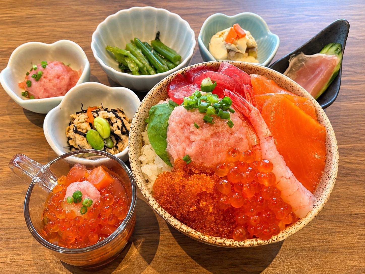 A variety of Japanese dishes including sashimi, rice, and caviar.
