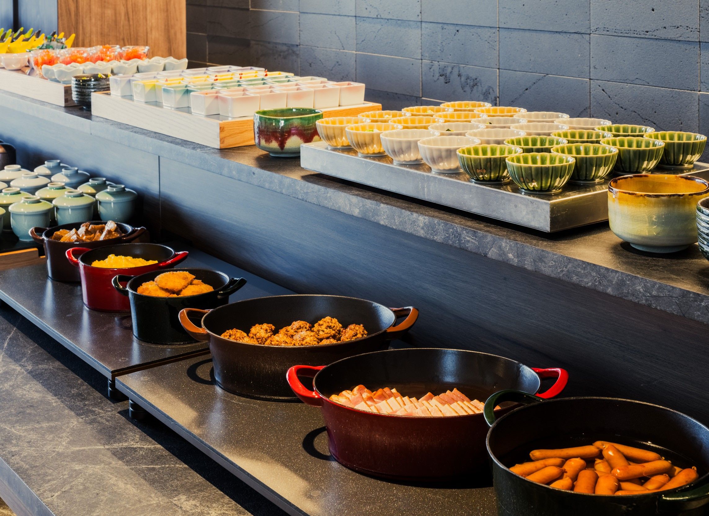 A buffet setup with various food items and serving dishes.