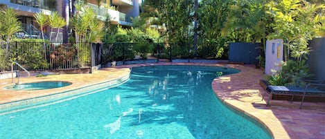 Outdoor pool, a heated pool, pool umbrellas, pool loungers