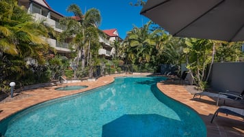 Outdoor pool, a heated pool, pool umbrellas, pool loungers