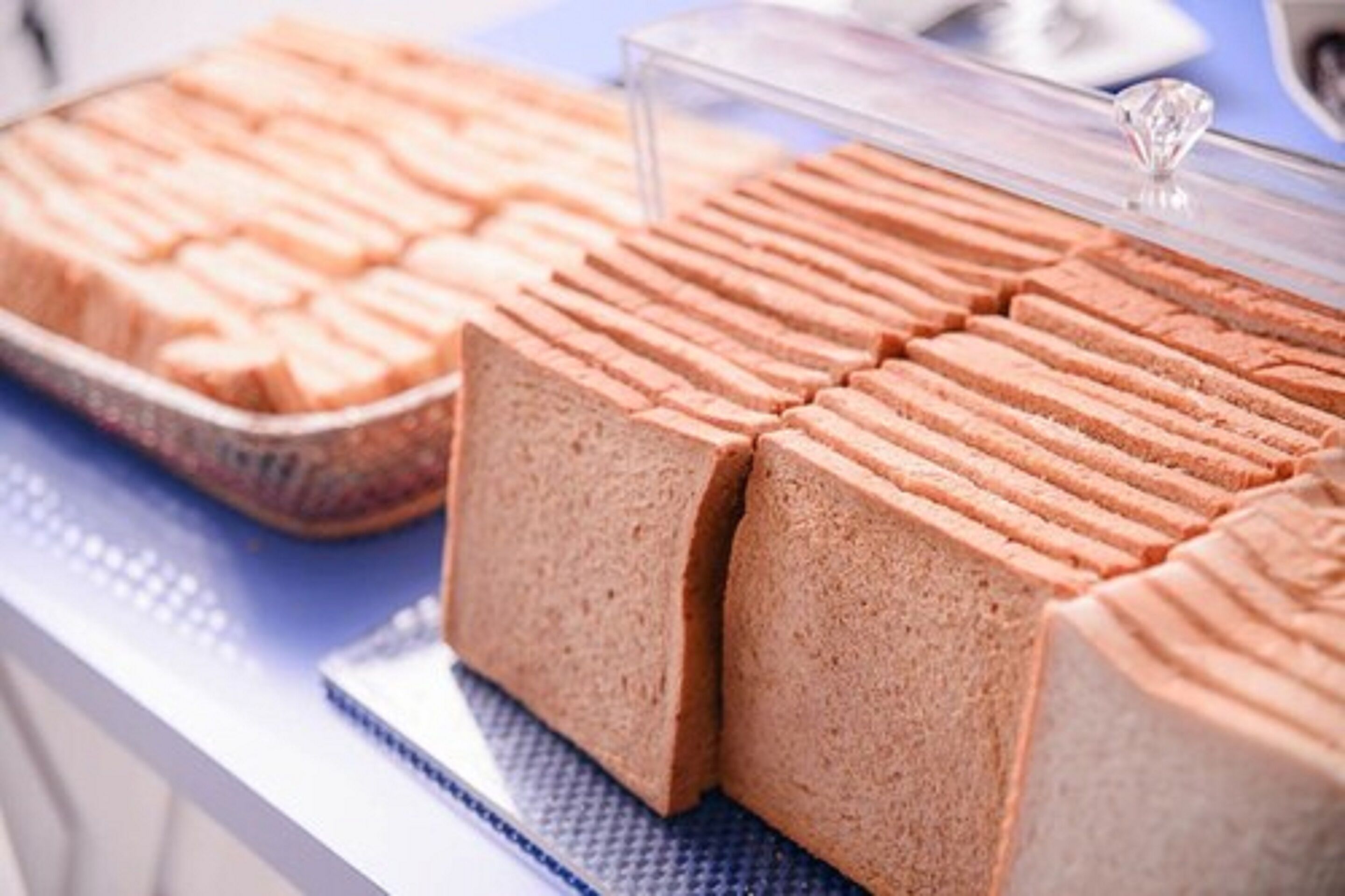 A display of sliced bread in a bakery setting.