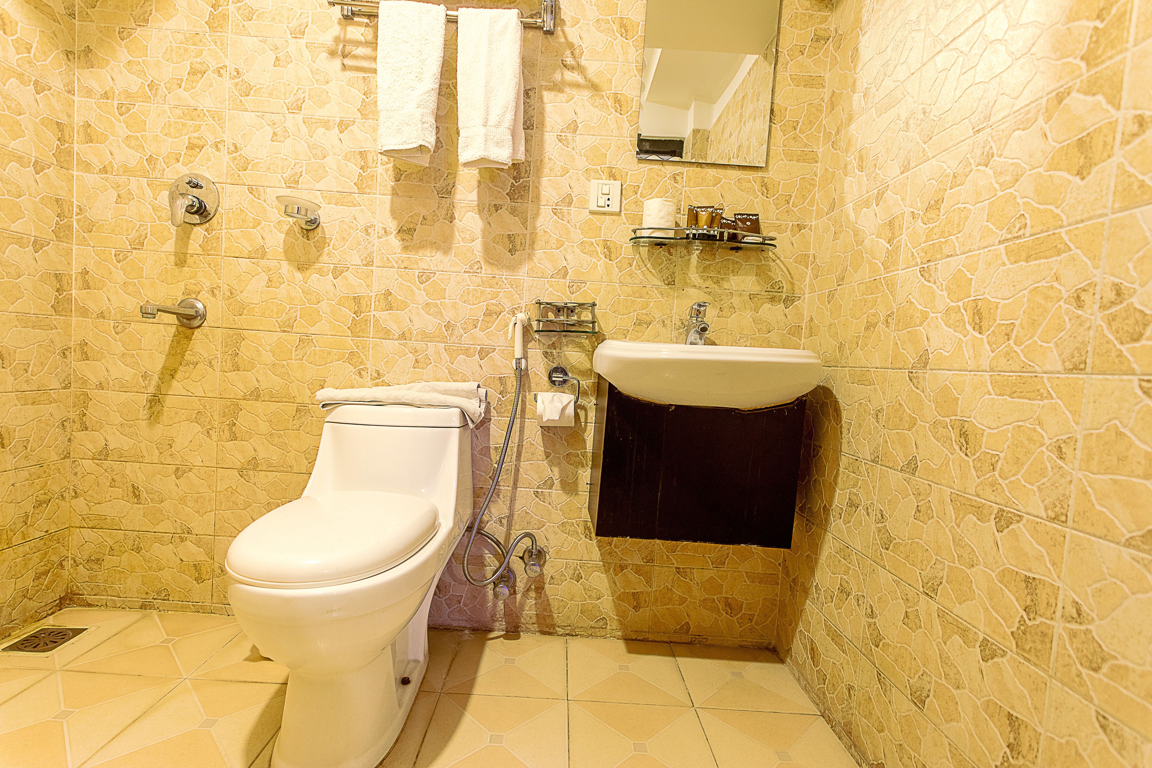 studio single | bathroom | shower, rainfall showerhead, slippers, towels