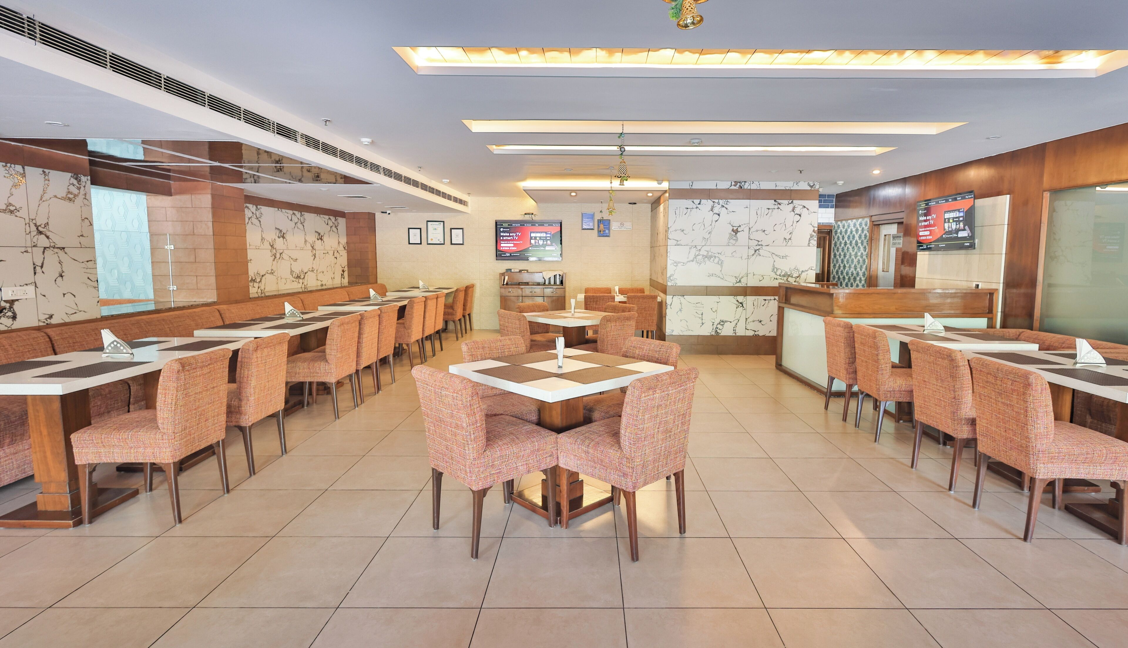 A restaurant with multiple seating areas, including booths and tables, and a counter for ordering.
