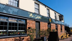 A building with a sign reading "The Globe Inn" and a logo indicating it serves food all day. - The Globe Inn (Tiverton)