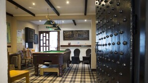 A billiards room with a pool table, chairs, and a sign for Jack Daniel's Tennessee Bourbon Whiskey. - Gilpin Bridge Inn (Kendal)