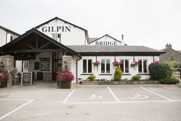 A building with a sign reading "GILPIN BRIDGE" and a parking area with bicycle symbols.