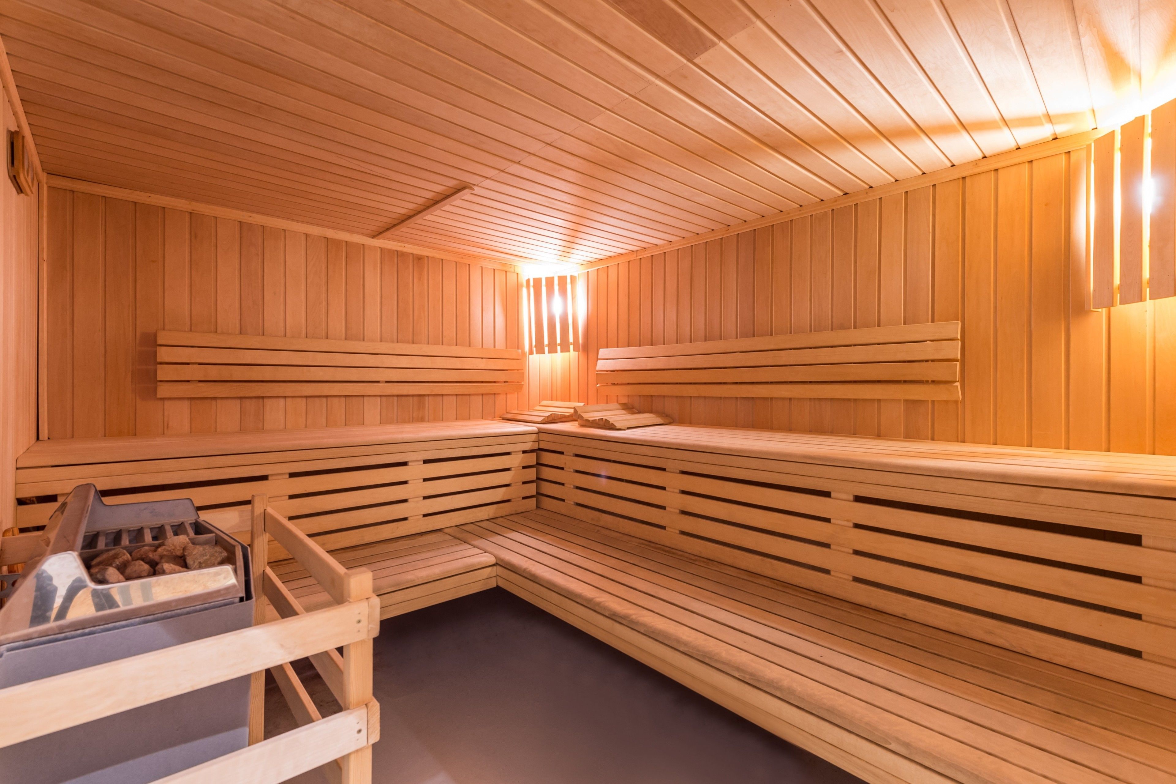 A sauna with wooden benches and a bench with a bench seat.