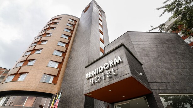 A hotel with a modern design, featuring a prominent 'Benidorm Hotel' sign.