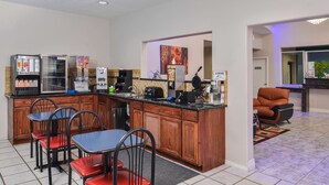 Une cuisine dotée d’un îlot central, de tabourets de bar et d’une machine à café.