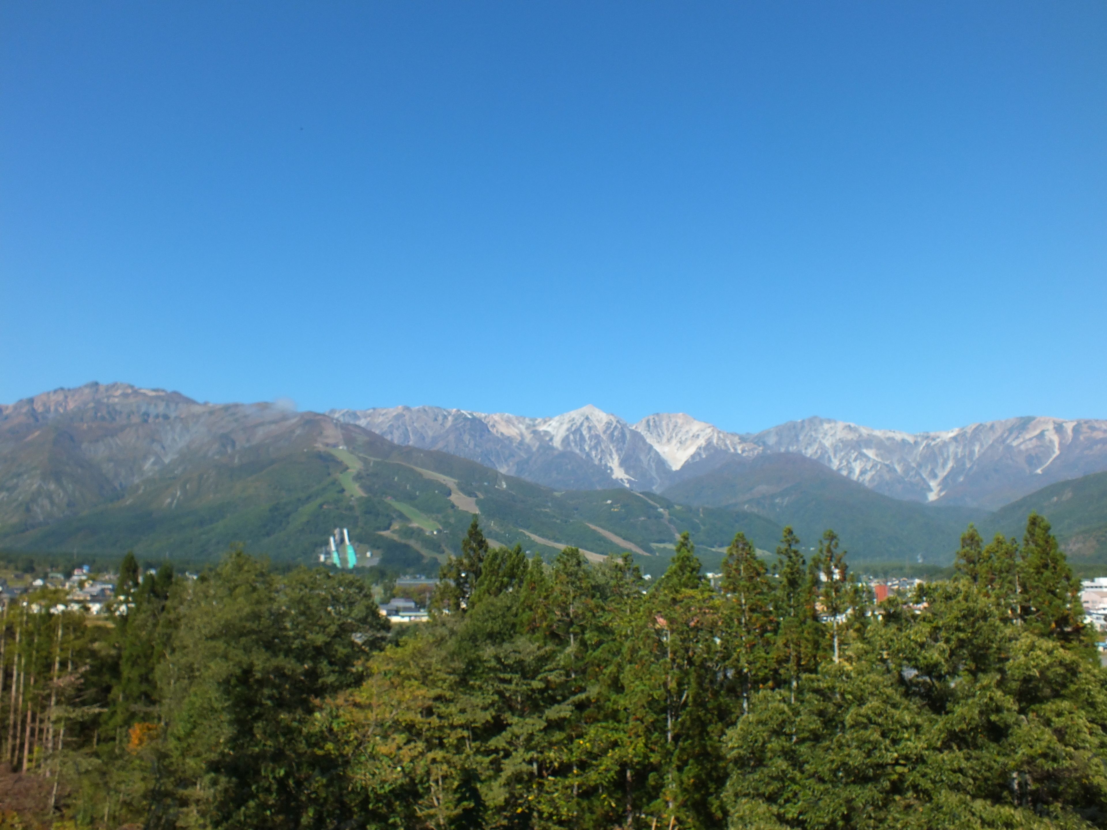 A mountainous landscape with a clear blue sky.