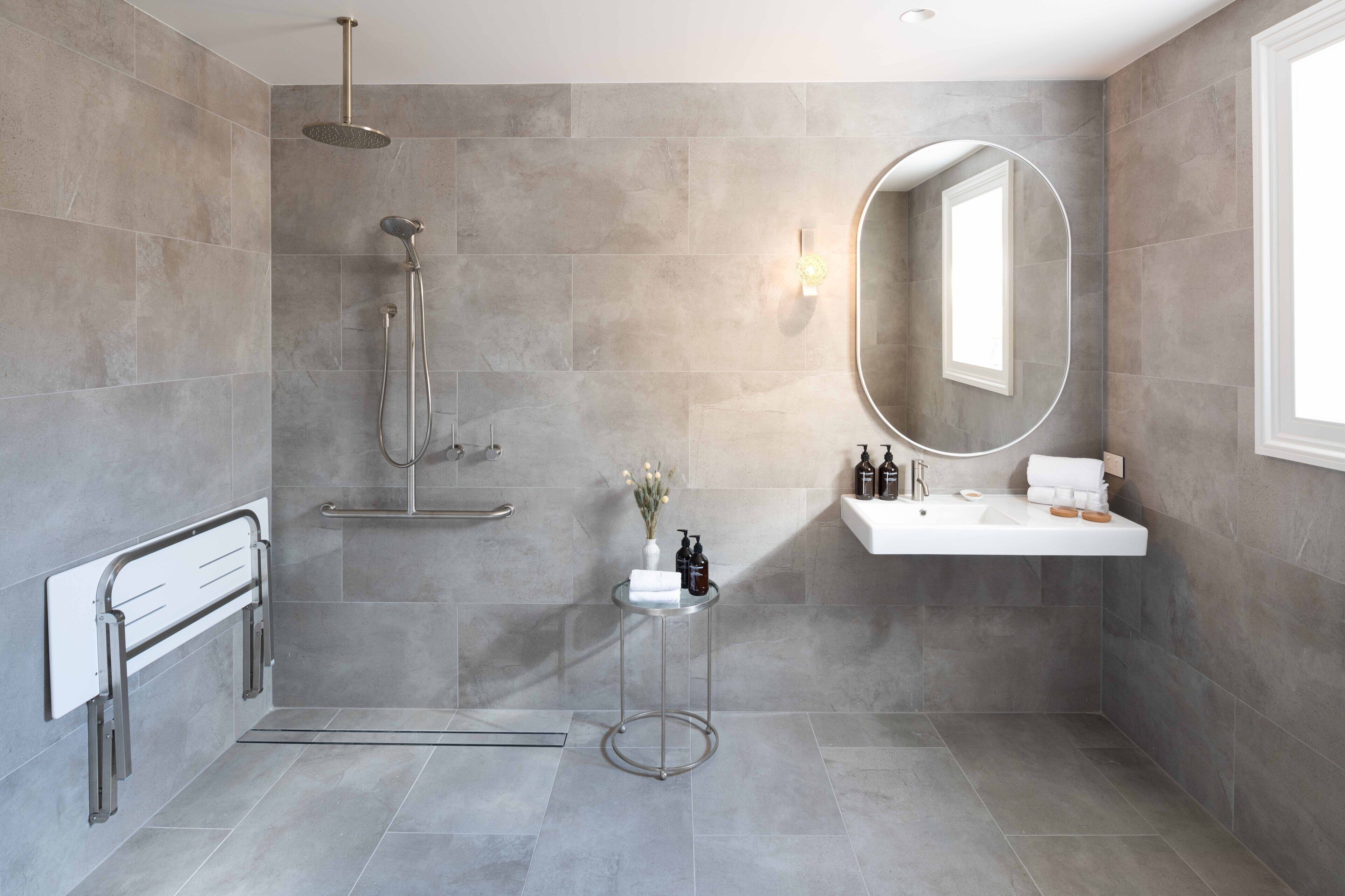A modern bathroom with a shower, a vanity, and a mirror.