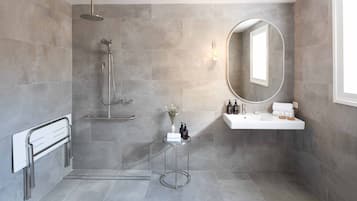 A modern bathroom with a shower, a vanity, and a mirror.