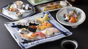 A variety of sushi dishes on different plates.