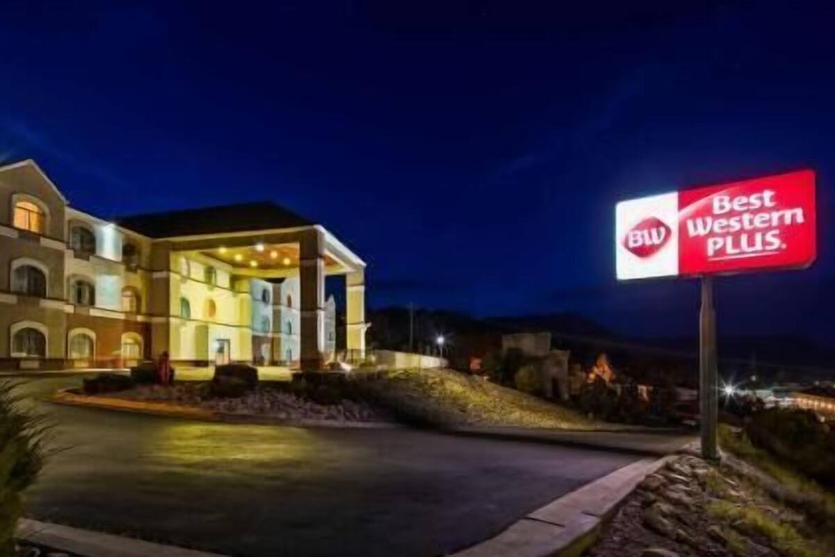 A hotel with a large entrance, a sign reading 'Best Western PLUS,' and a well-lit facade.
