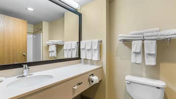 A bathroom with a sink, mirror, towel rack, and toilet.