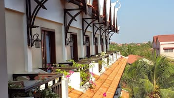 A row of traditional Thai-style buildings with tiled roofs and ornate decorations.