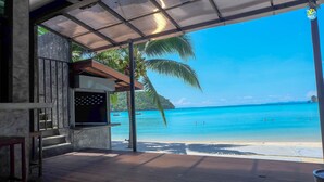 A covered outdoor area with a view of a beach and ocean. - Ibiza House Phi Phi  (Ko Phi Phi)