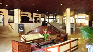 A lobby with a staircase, seating area, and a bar. - Miramar São Tomé (São Tomé)
