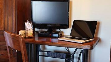 A wooden desk with a laptop and a monitor.