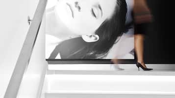 A staircase with a large poster of a woman.