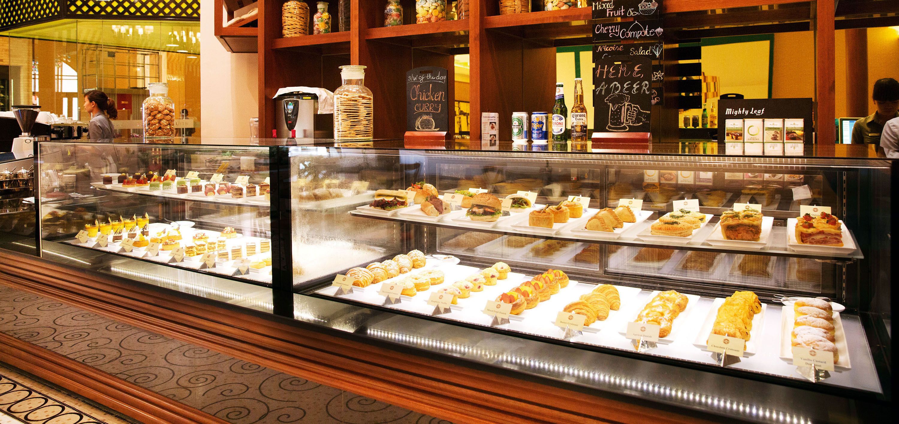 A bakery display case with various pastries and desserts.