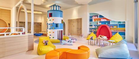 A children's play area with colorful furniture and a playful design.