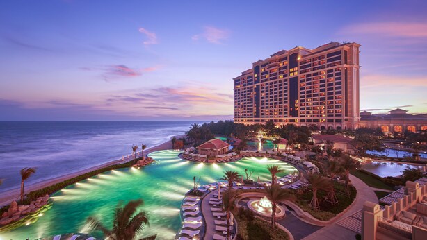 A resort with a large pool, a beach, and a hotel building. - InterContinental Grand Ho Tram by IHG (Ho Chi Minh City)