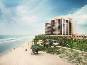 A beachfront hotel with a pool, beach, and palm trees. - InterContinental Grand Ho Tram by IHG (Ho Chi Minh City)