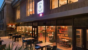 A Dublin Irish Pub with outdoor seating and a neon sign advertising 'Sunset Magic: VIP Kick Off Cocktails'. - Ramada by Wyndham Tashkent (Tashkent)