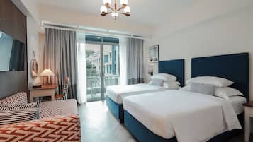 Deluxe Room, Pool View | Minibar, in-room safe, individually decorated, desk