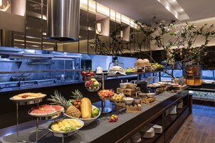 A buffet with various fruits and dishes.
