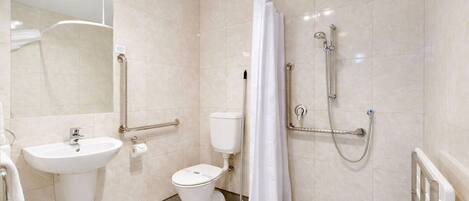 Un baño moderno con lavamanos, inodoro y ducha.