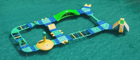 A pool with a floating play structure.