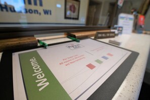 A welcome sign with a green border and a message about non-smoking rooms.