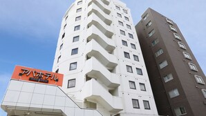 A multi-story hotel with a prominent orange sign indicating it is the "Alphotel." The building features a modern architectural design with balconies on each floor. - APA Hotel Sagamihara Hashimoto Ekimae (Sagamihara)
