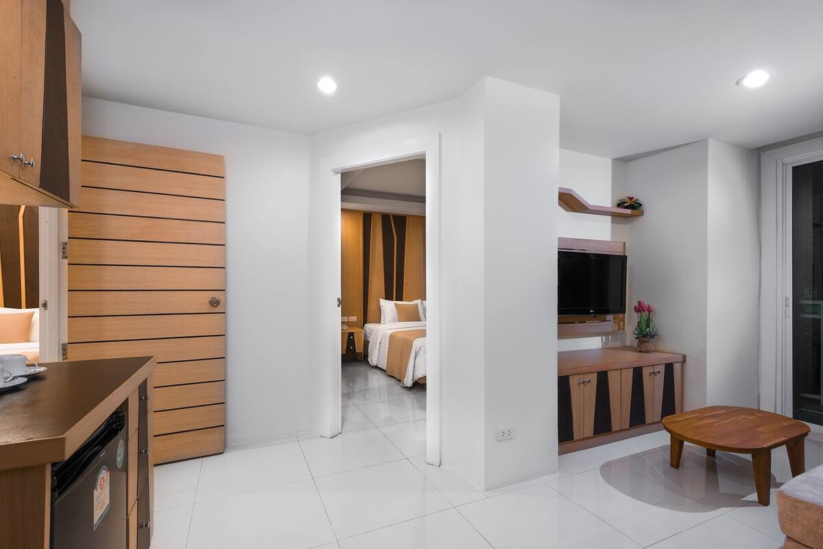 Two-Bedroom Suite | Oppholdsområde | En 32-tommers LCD-TV med kabel-kanaler samt TV