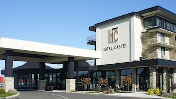 Hotel Castle offers a grand entrance with a covered area and landscaped surroundings.