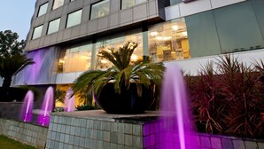 A modern building with a prominent sign reading "THE ALTUS."
