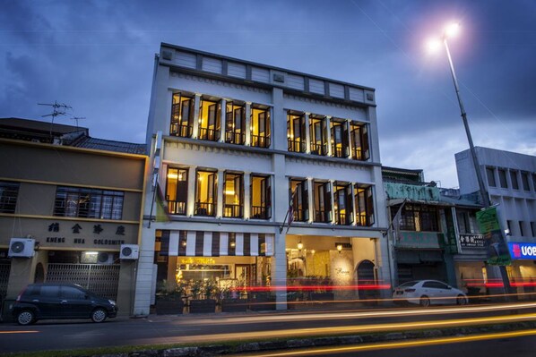A multi-story building with a ground-floor shop and upper-floor residential units. - The Ranee Boutique Suites (Kuching)