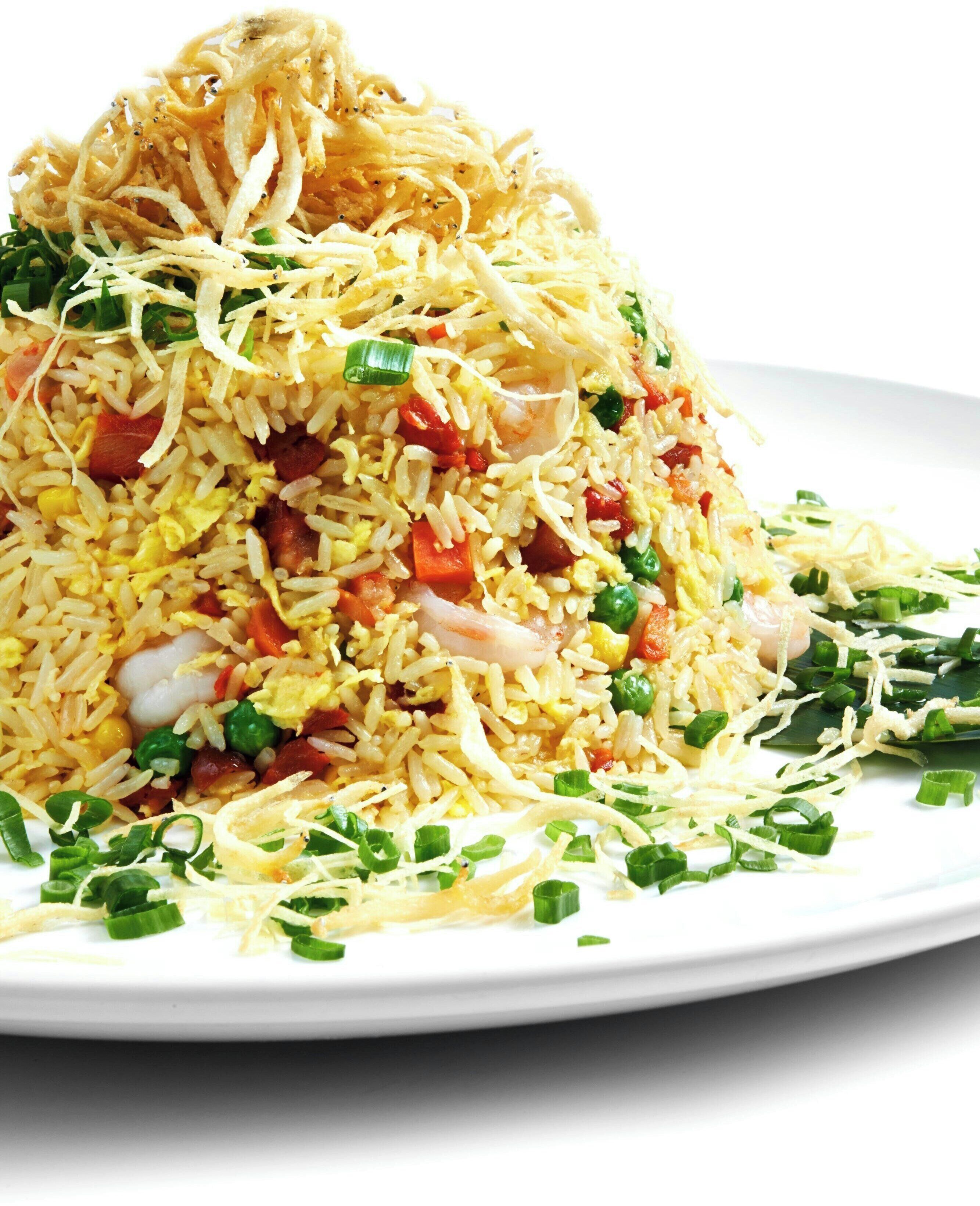 A plate of fried rice with vegetables and shrimp.